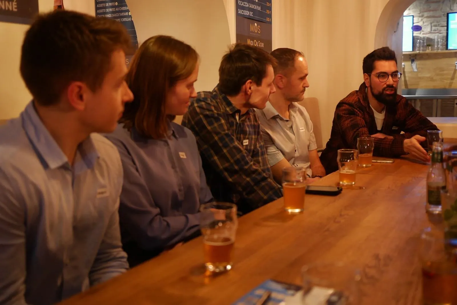 Des membres attablés au comptoir pendant une soirée à Lyon